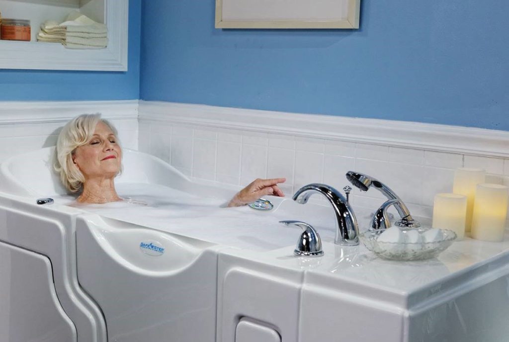 Woman peacefully relaxing in a Safe Step Walk-In Tub, she appears at ease, with her eyes closed, enjoying the comfort of the bath. The tub's design is visible, showcasing its safety features and ergonomic structure.